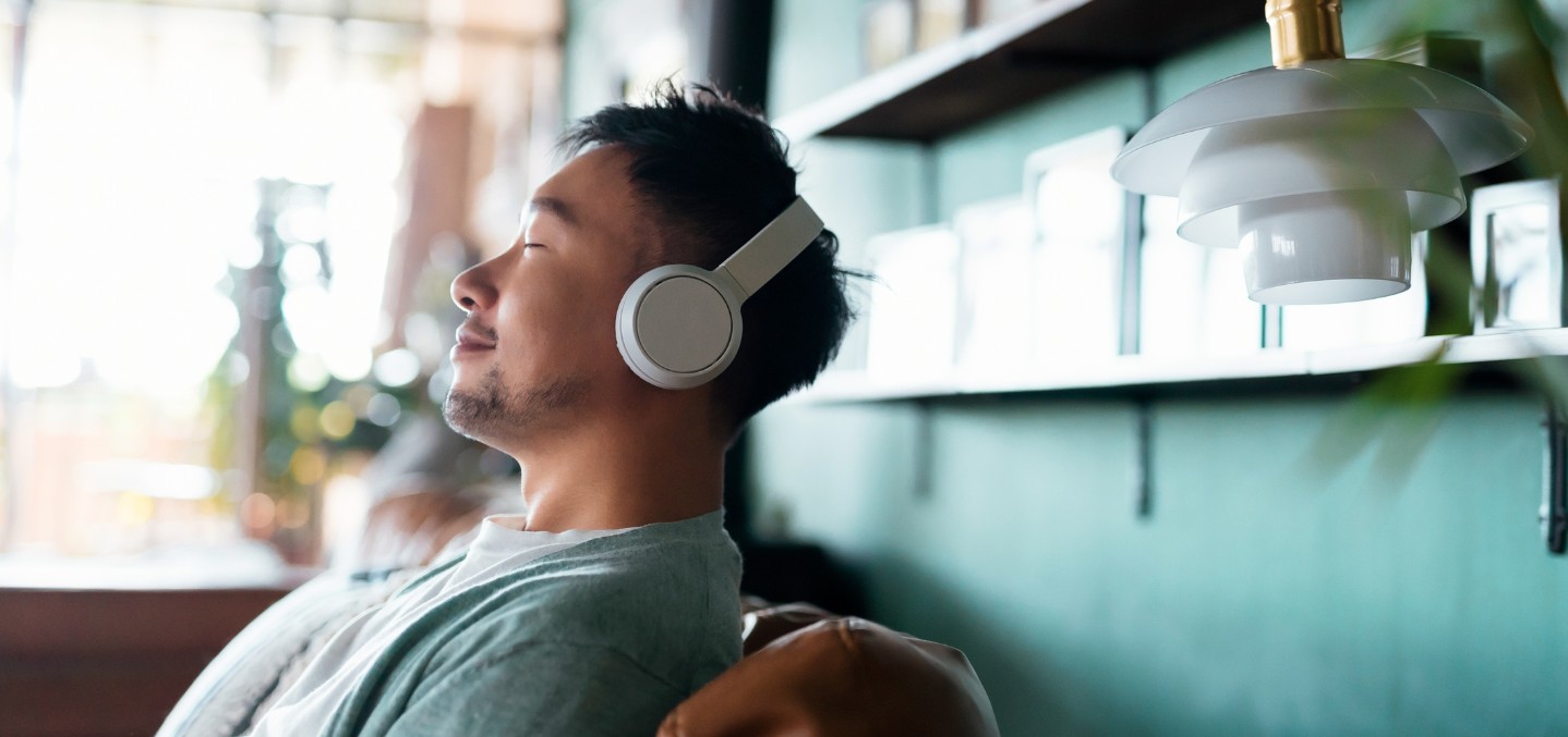 Man relaxing and listening to music on his headphones