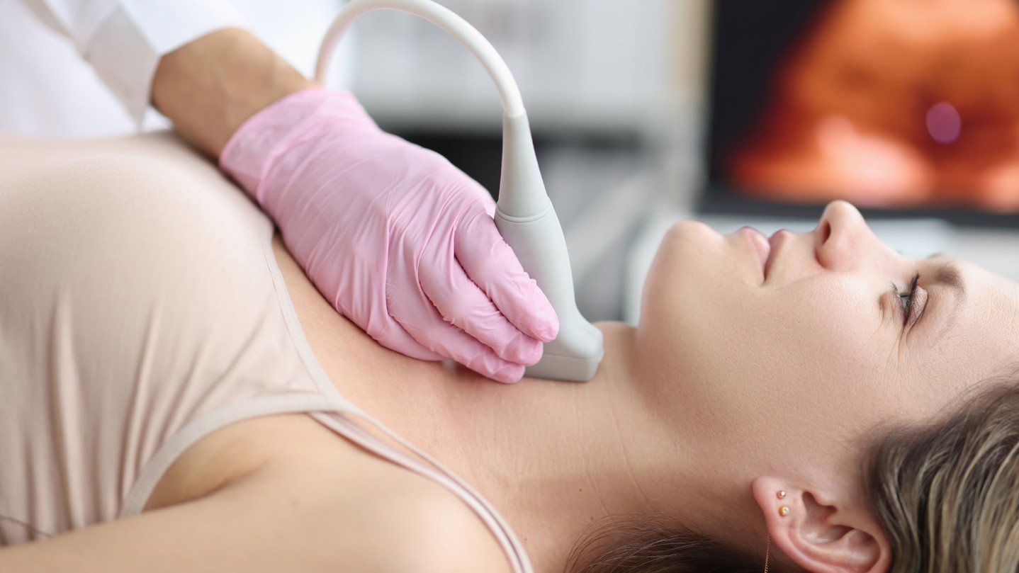 Woman receiving ultrasound on her neck